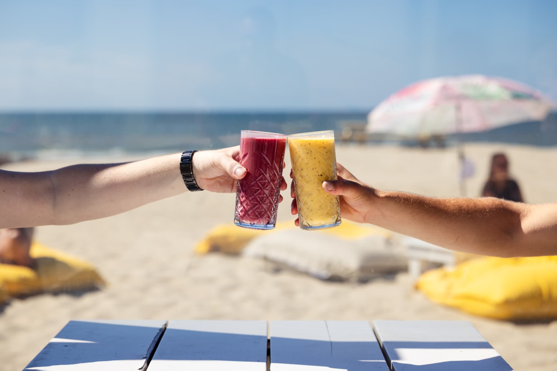 Toasting with smoothies on the beach at Paal 28